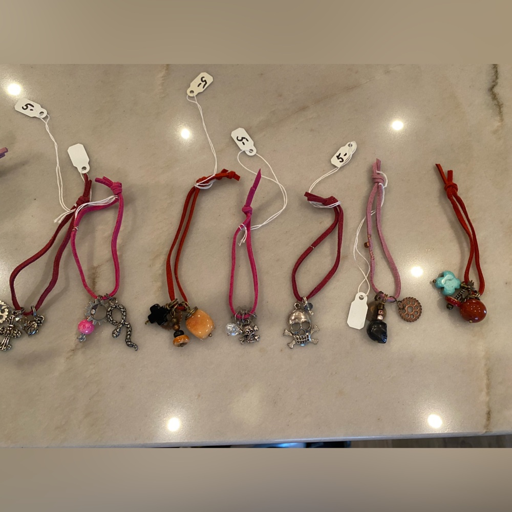 Charmed! A bundle of handmade suede wristlets with intriguing charms.